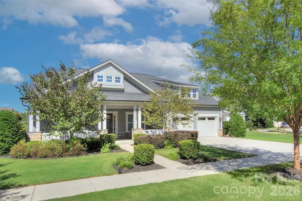 Front of a gray one-level ranch home with a covered front porch and two-car garage